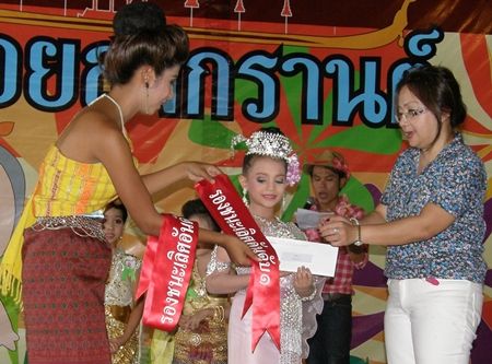 Chanissara Katie Marsh receives her sash and envelope from the emcee, for being placed ‘after second’.